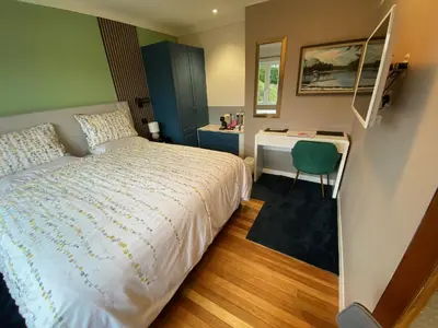 a small bedroom with a bed and a desk at Westwood - The B&B with a view in Cockermouth