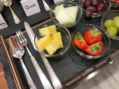 a table topped with bowls of fruit and vegetables at Westwood - The B&B with a view in Cockermouth