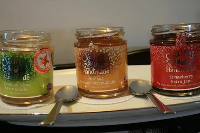 three jars of jam on a tray with spoons at Westwood - The B&B with a view in Cockermouth