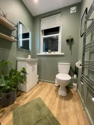 a bathroom with a toilet and a window at Rivendell Guest House in Keswick