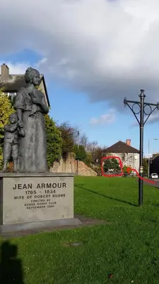 a statue of a mother and her children in a park at Dumfries Central apartment in Dumfries