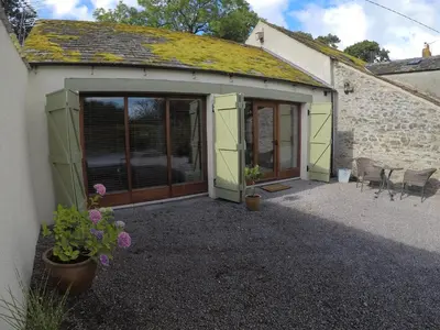 a garage with a door and a building at The Little Fish in Cockermouth