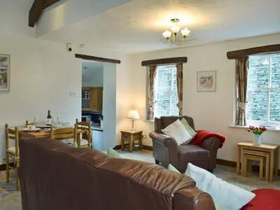 a living room with a couch and chairs and a table at Latrigg View in Keswick