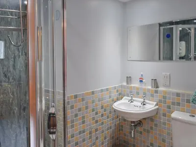 a bathroom with a sink and a shower at Saddleback in Keswick
