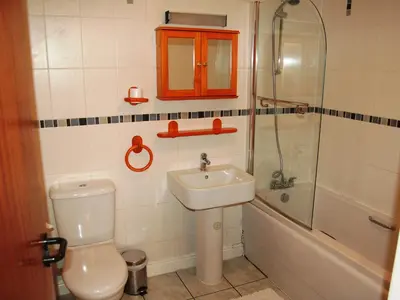 a bathroom with a toilet and a sink and a shower at Topsey Turvey in Keswick