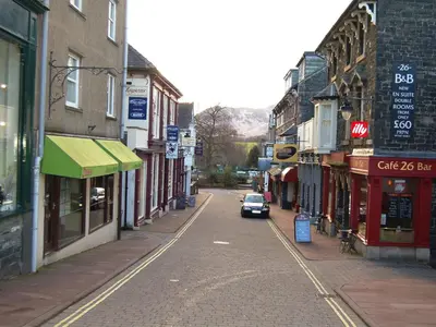 a car driving down a street in a town at Royal Views in Keswick
