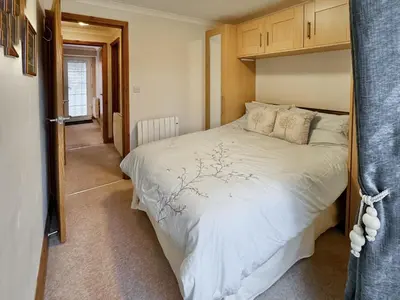 a bedroom with a large white bed in a room at 2 Greta Side Court in Keswick