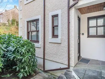 a house with a mirror on the side of it at Olivet - Hewetson Court in Keswick