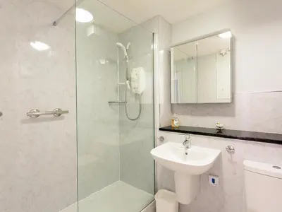 a bathroom with a glass shower and a sink at Beech Nut in Keswick