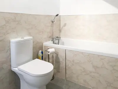 a bathroom with a white toilet and a sink at Wendover in Keswick