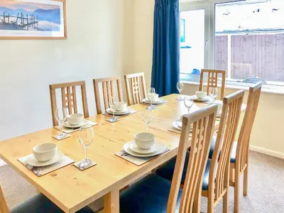a dining room table with chairs and a wooden table and a table and chairsktop at Wendover in Keswick