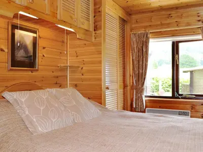 a bedroom with a bed and a window at Acorn Lodge - Burnside Park in Keswick