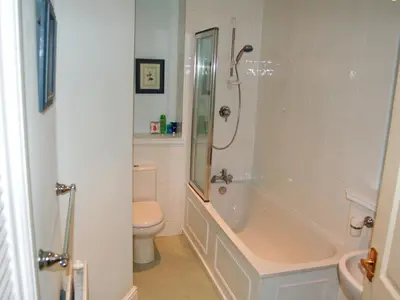 a bathroom with a shower and a tub and a toilet at Brundholme in Keswick