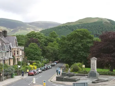 a street in a small town with cars parked at Brundholme in Keswick
