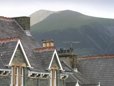 a group of roofs with a mountain in the background at Brundholme in Keswick