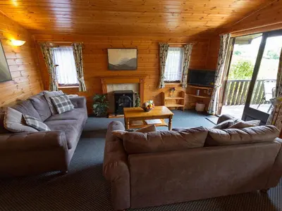 a living room with two couches and a fireplace at Whiteside Lodge At Burnside Park in Keswick