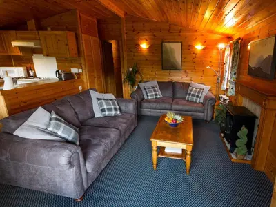 a living room with two couches and a coffee table at Whiteside Lodge At Burnside Park in Keswick