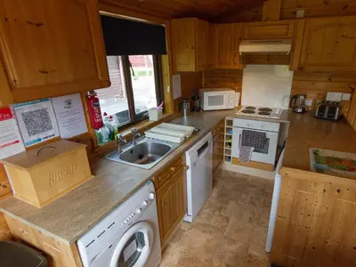 a small kitchen with a sink and a stove at Whiteside Lodge At Burnside Park in Keswick