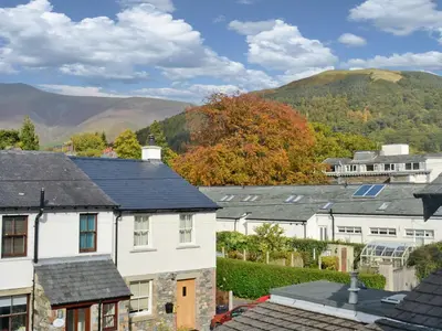 a group of houses with mountains in the background at Serendipity in Keswick