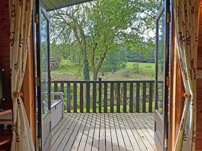 a screened porch with a view of a tree at Ewe How - Burnside Park in Keswick