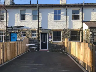 a house with a bench in front of it at 3 Catherine Cottages in Keswick