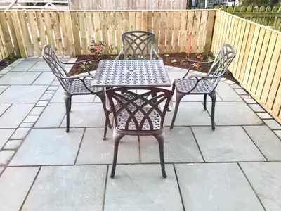 a table and four chairs on a patio at 3 Catherine Cottages in Keswick