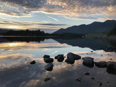 a view of a lake with rocks in the water at 3 Catherine Cottages in Keswick
