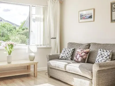 a living room with a couch and a window at Blencathra Bank in Keswick