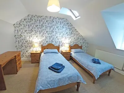 two twin beds in a room with two lamps at Carthwaite in Keswick