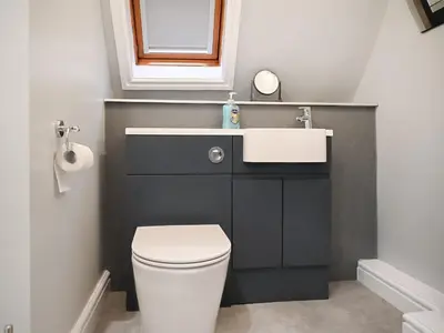 a bathroom with a sink and a toilet at Millie's Cottage in Keswick