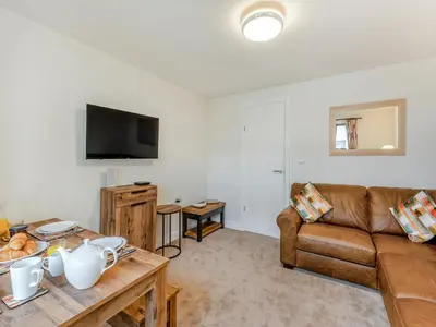 a living room with a couch and a table at Kissing Gate in Keswick