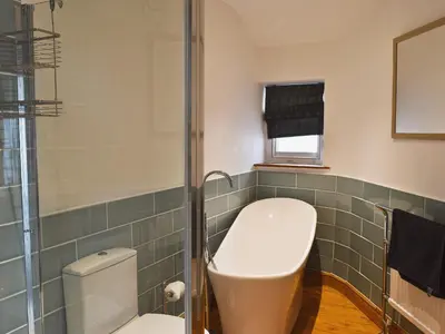 a bathroom with a toilet and a sink at Acorn Lodge Cottage in Keswick