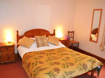 a bedroom with a large bed and two night stands at Alvamere in Keswick