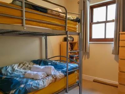 a bedroom with bunk beds in a room with a window at Bleaberry- Hewetson Court in Keswick