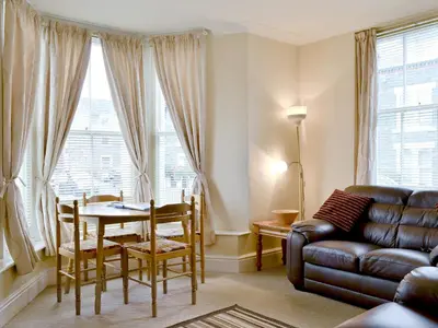 a living room with a couch and a table at Helvellyn House Apartment in Keswick