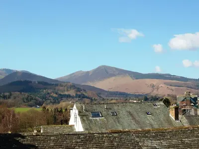 a group of houses with mountains in the background at 3 The Hollies in Keswick
