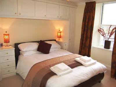 a bedroom with a bed with two towels on it at 3 The Hollies in Keswick
