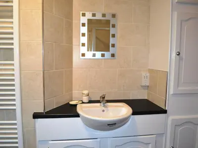 a bathroom with a sink and a mirror at Wickhams View in Keswick