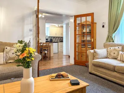 a living room with a couch and a table at Lavender Cottage in Keswick