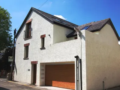 a large white house with a garage at The Old Laundry 1 in Keswick
