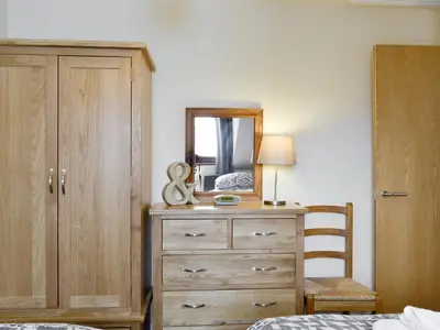 a bedroom with a dresser and a mirror at The Old Laundry 4 in Keswick