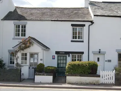 a white house with a gate in front of it at Laal Yan in Keswick