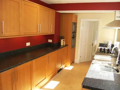 a kitchen with wooden cabinets and a sink at York House in Keswick
