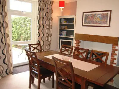 a dining room with a wooden table and chairs at York House in Keswick
