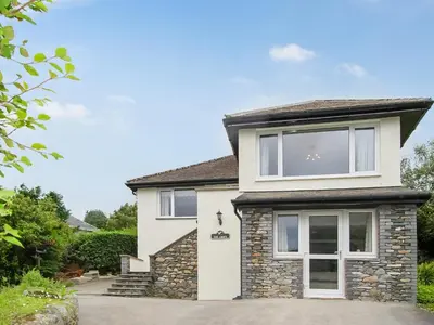 a house with white windows and a driveway at The Croft in Keswick