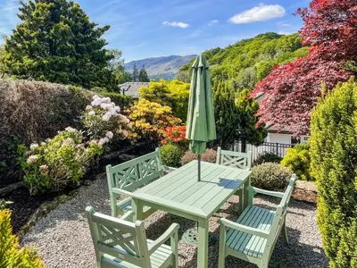 a table and two chairs and an umbrella at The Croft in Keswick
