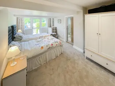 a bedroom with a bed and a large window at The Croft in Keswick