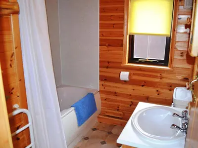 a bathroom with a sink and a toilet and a tub at Glenmore Lodge in Keswick