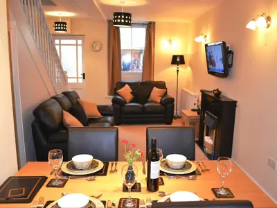 a living room with a dining table and a living room at Uncle's Cottage in Keswick