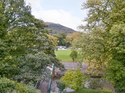 a view from the top of a garden with trees at Riverbank in Keswick